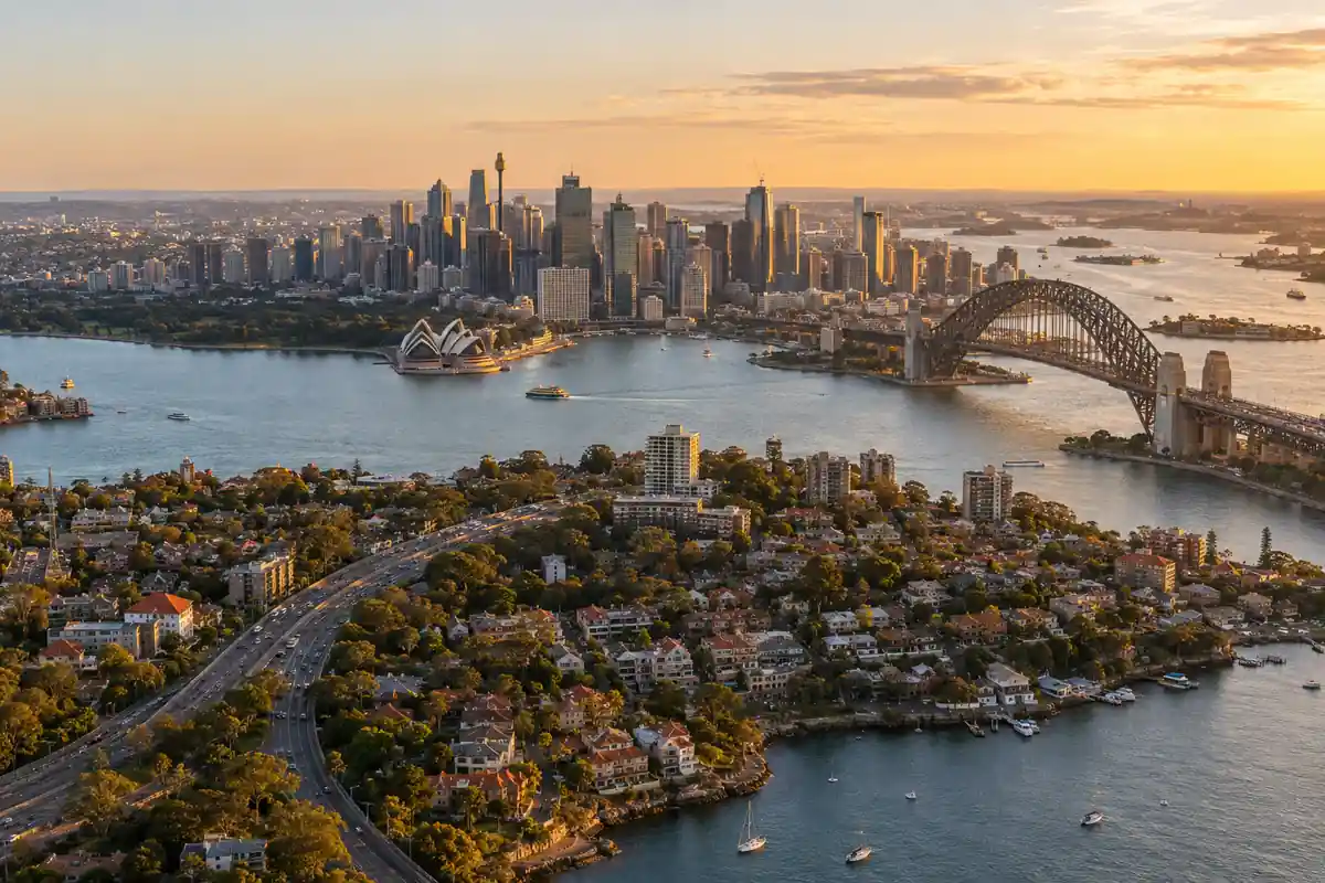 Aerial view across Sydney Harbour to the city at golden hour